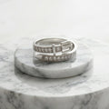 Marble ring holder with a trendy belt 925 sterling silver ring by CHAKORE on a white background