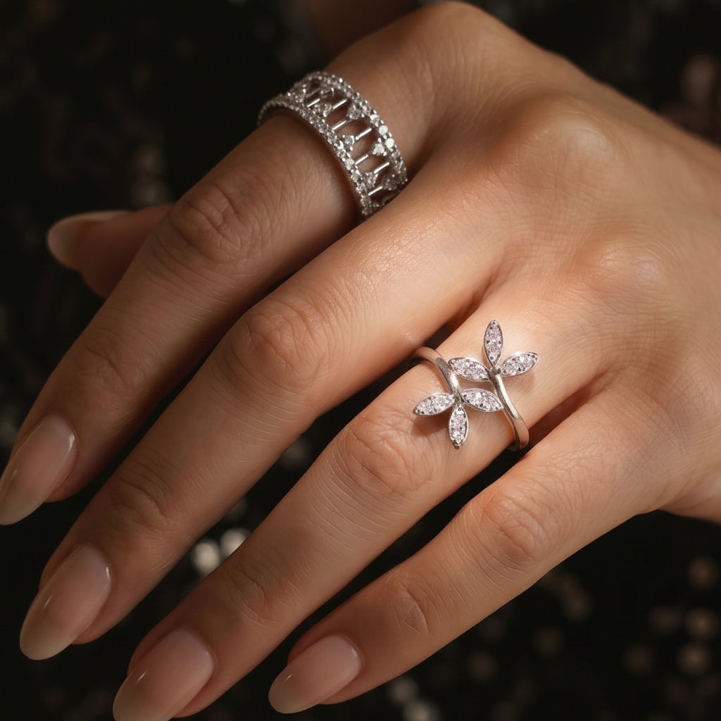 Uncluttered elegance 925 silvering by CHAKORE. Hand wearing two rings with intricate designs on a dark background